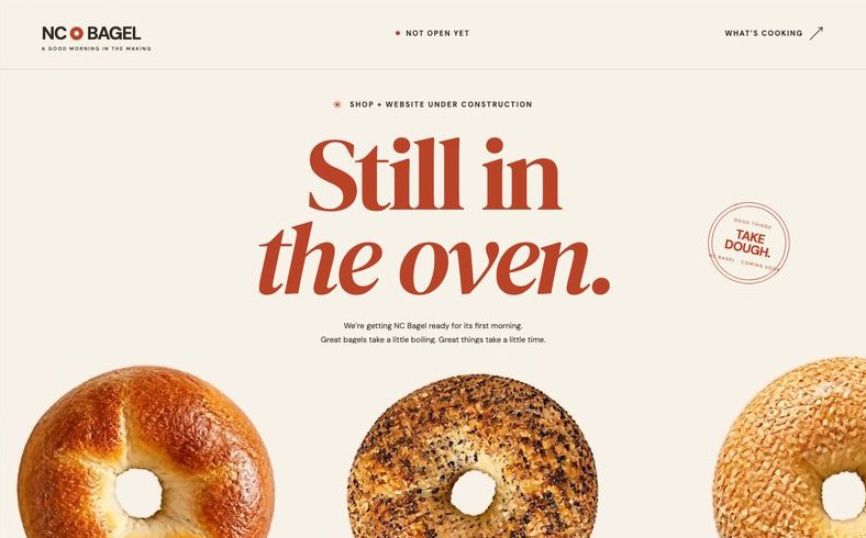 NC Bagel’s coming-soon page on a laptop, headline “Still in the oven.” above a row of bagels